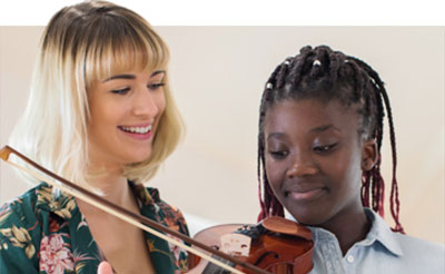 teacher instructing student playing violin