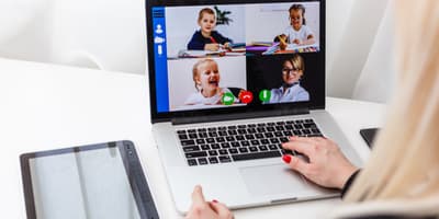 Woman video conferencing with children