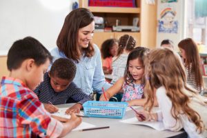 Teacher helping students in classroom