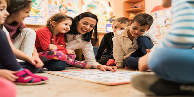 preschool teacher teaching young students