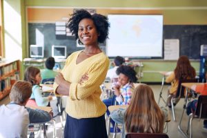 female teacher in classroom with young students