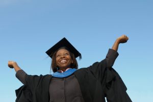 woman in cap and gown graduating with masters degree