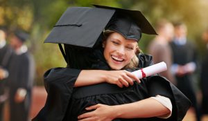 group of graduates in caps and gowns celebrating their masters degrees