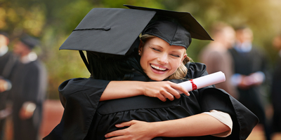group of graduates hugging
