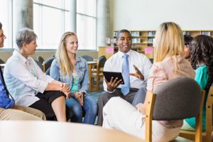 group of teachers sitting in a circle learning from each other