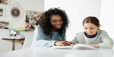 woman tutoring child