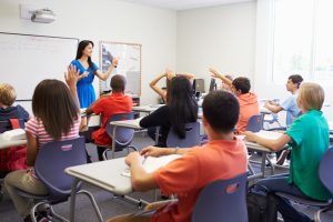 teacher standing in front of the classroom teaching students