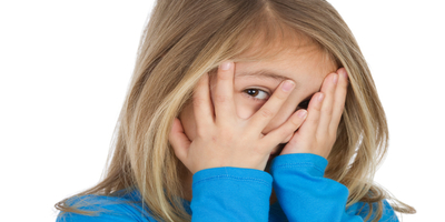 shy child covering her face