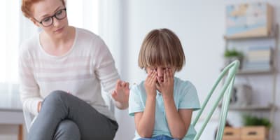 Child holding his head in his hands