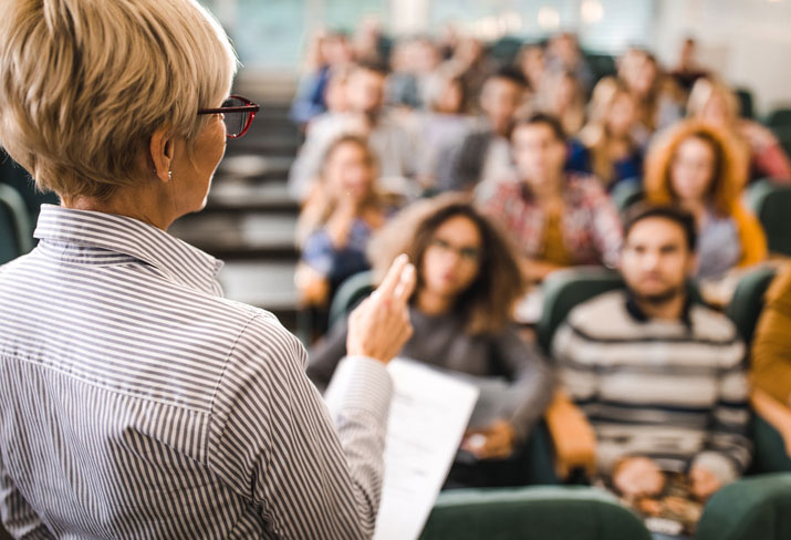 Professor lecturing class students