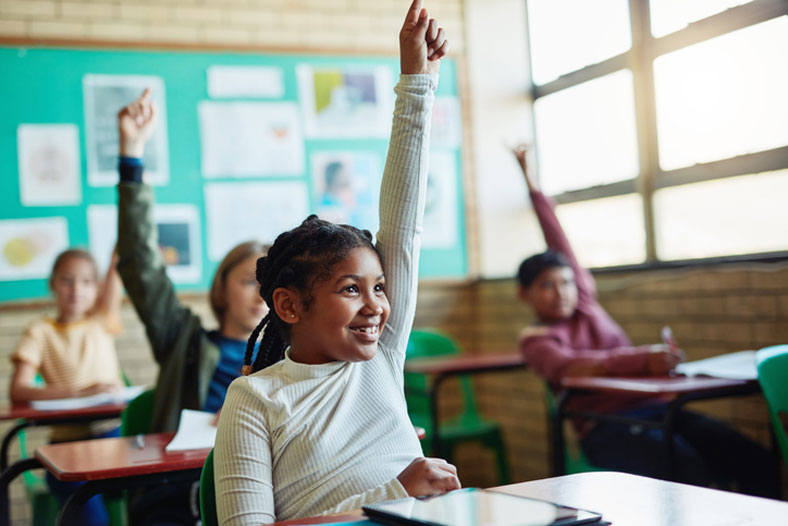 kids raising hands in class